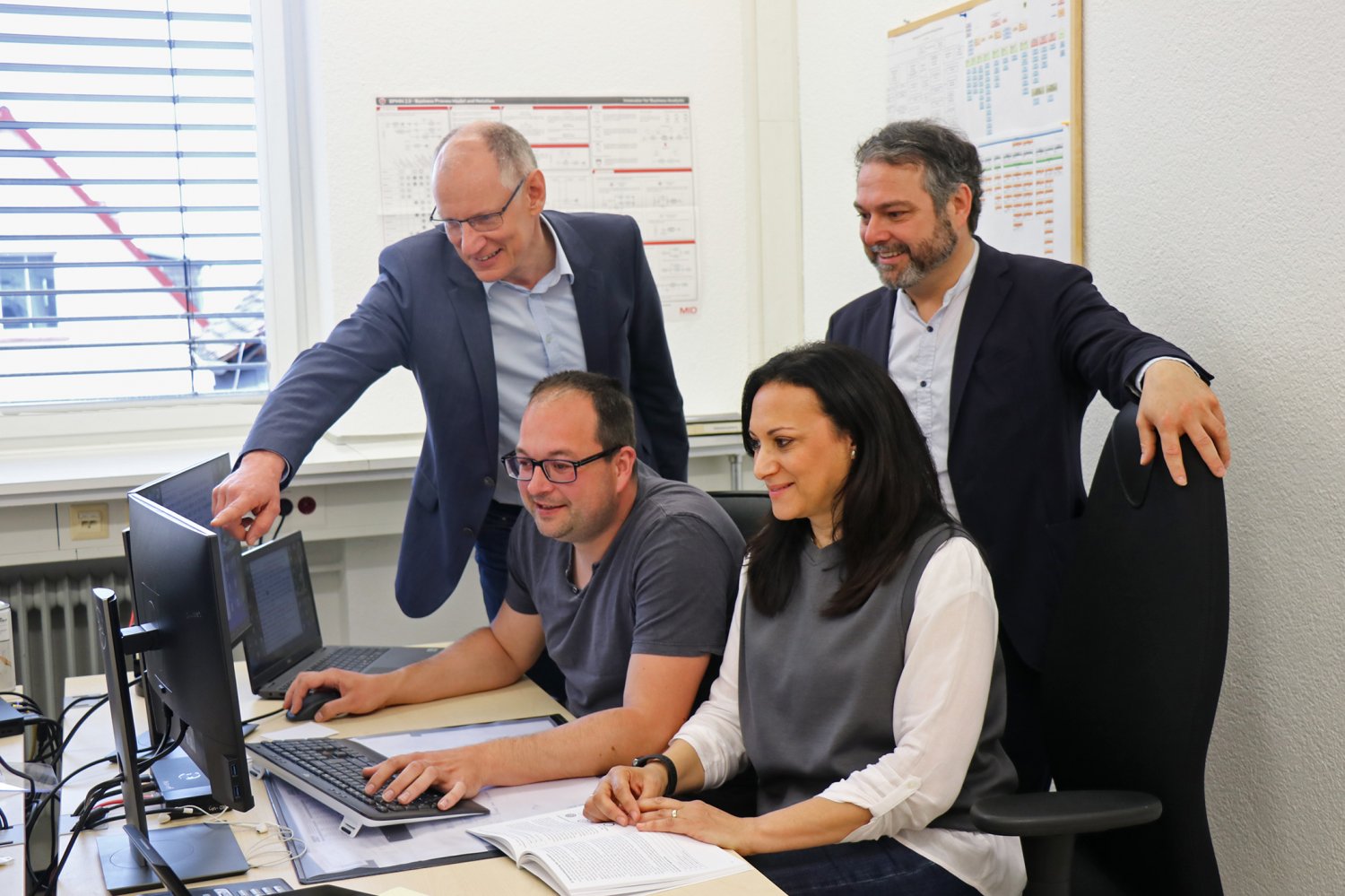 Freuen sich auf eine rege Teilnahme der Eltern an der Meinungsumfrage: Jane Kolczok und Dennis Naumann (sitzend), Bürgermeister Daniel Chr. Glöckner und Stefan Bechtold (links).