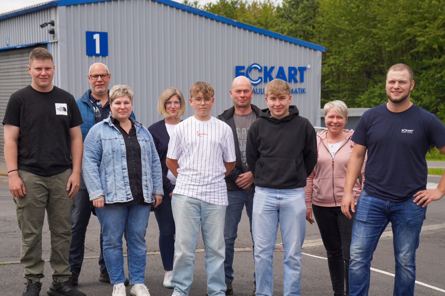 Eckart-Ausbildungsleiter Patrick Hofacker (rechts) begrüßte seine neuen Auszubildenden Paul, Max, Luca (Erster, Fünfter und Siebter von links) sowie deren Eltern für einen kurzen Kennenlern-Rundgang. 